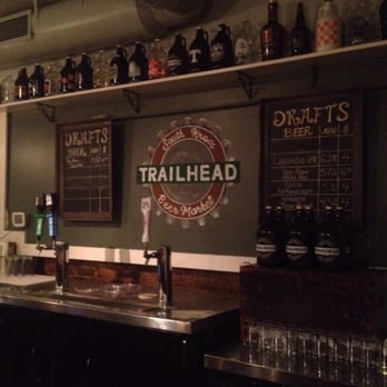 Trailhead Beer Market - Behind the bar: 2 chalkboards with what's on draft, awesome artwork of the Trailhead logo, and so many growlers!! - Beer Bar Near Me - Knoxville, Tennessee Trailhead Beer Market - Behind the bar: 2 chalkboards with what's on draft, awesome artwork of the Trailhead logo, and so many growlers!! - Beer Bar Near Me - Knoxville, Tennessee