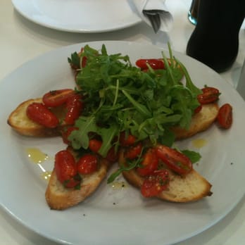 Portici - bruschetta with cherry tomatoes, olive oil and arugula. So fresh, light, and flavorful! - Italian Near Me - Toronto, Ontario Portici - bruschetta with cherry tomatoes, olive oil and arugula. So fresh, light, and flavorful! - Italian Near Me - Toronto, Ontario