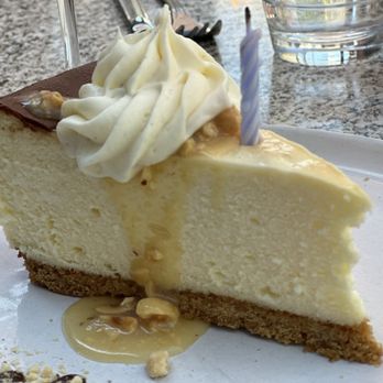 Revelry - CHEESECAKE - 12 Graham cracker crust, cream cheese filling, hazelnut caramel, chocolate ganache & vanilla whipped Irish Cream - Wine Bars Near Me - Bozeman, Montana