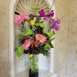 Incredible 2 tier display with orchids draped through the vase and a gorgeous arrangement on top.