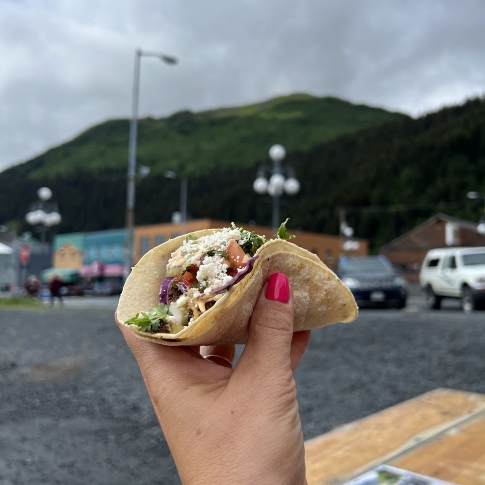 Los Chanchitos - a hand holding a taco - Food Trucks Near Me - Seward, Alaska Los Chanchitos - a hand holding a taco - Food Trucks Near Me - Seward, Alaska