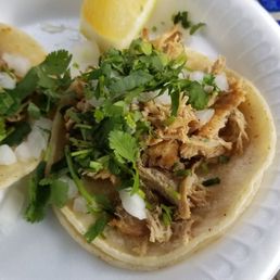 two tacos on a paper plate