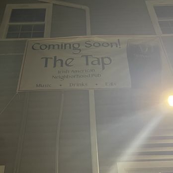 The Tap - The Tap! - A banner outside a building advertises the opening of The Tap Irish American neighborhood pub, featuring music, drinks, and food. - Pubs Near Me - Cumberland, Rhode Island