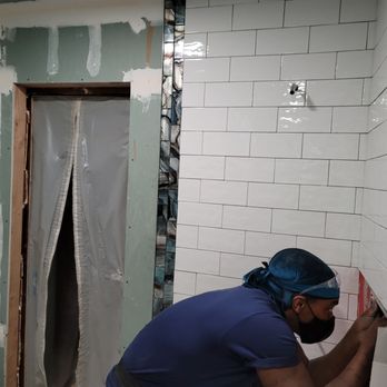 O'Wize Construction - a man working in a bathroom - Painters Near Me