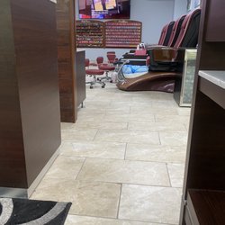 US Nail Spa - Inside the shop , foot tubs and various nail polishes on the wall.