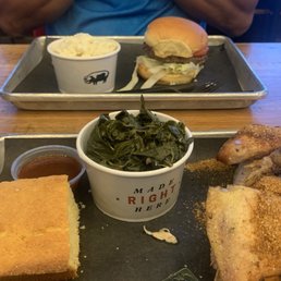 Chicken Platter with Southern greens and cornbread in foreground  Burger and cole slaw in background