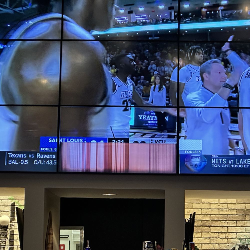 a basketball game being played on a big screen a basketball game being played on a big screen
