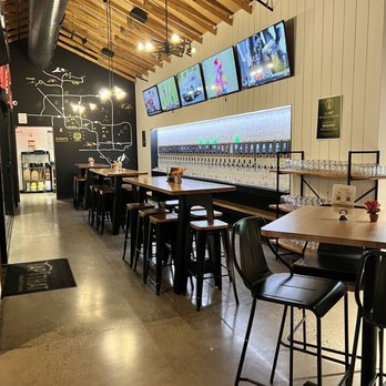 Tap That Downtown - a row of tables in a restaurant - Bars Near Me - Phoenix, Arizona Tap That Downtown - a row of tables in a restaurant - Bars Near Me - Phoenix, Arizona