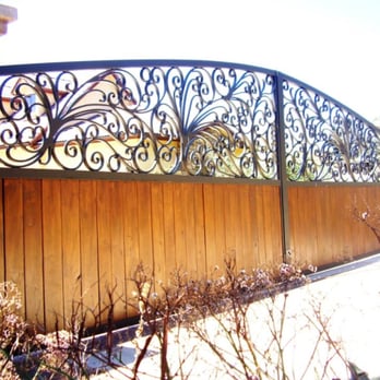 Evanart - a closeup of a wooden gate with wrought ironwork - General Contractors Near Me - Tecate, California Evanart - a closeup of a wooden gate with wrought ironwork - General Contractors Near Me - Tecate, California