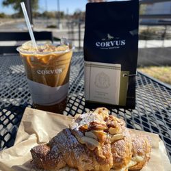 Corvus Coffee Roasters - Nawlins Iced coffee, Corvus bag of coffee, and a delicious pastry