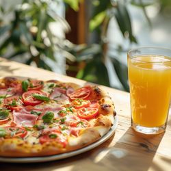 Pepe Pizza - A freshly prepared pizza with a variety of toppings, including ham slices, cherry tomatoes, and fresh basil.