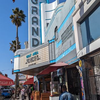 Gray Area - a man walking down a sidewalk in front of a movie theater - Community Service/Non-Profit Near Me - San Francisco, California Gray Area - a man walking down a sidewalk in front of a movie theater - Community Service/Non-Profit Near Me - San Francisco, California