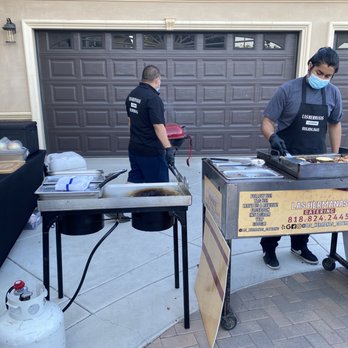 Las Hermanas Catering - two men preparing food - Caterers Near Me