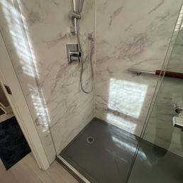 Tub to shower conversion ( sorry for reflection in pics).  All Kohler products with stone base.