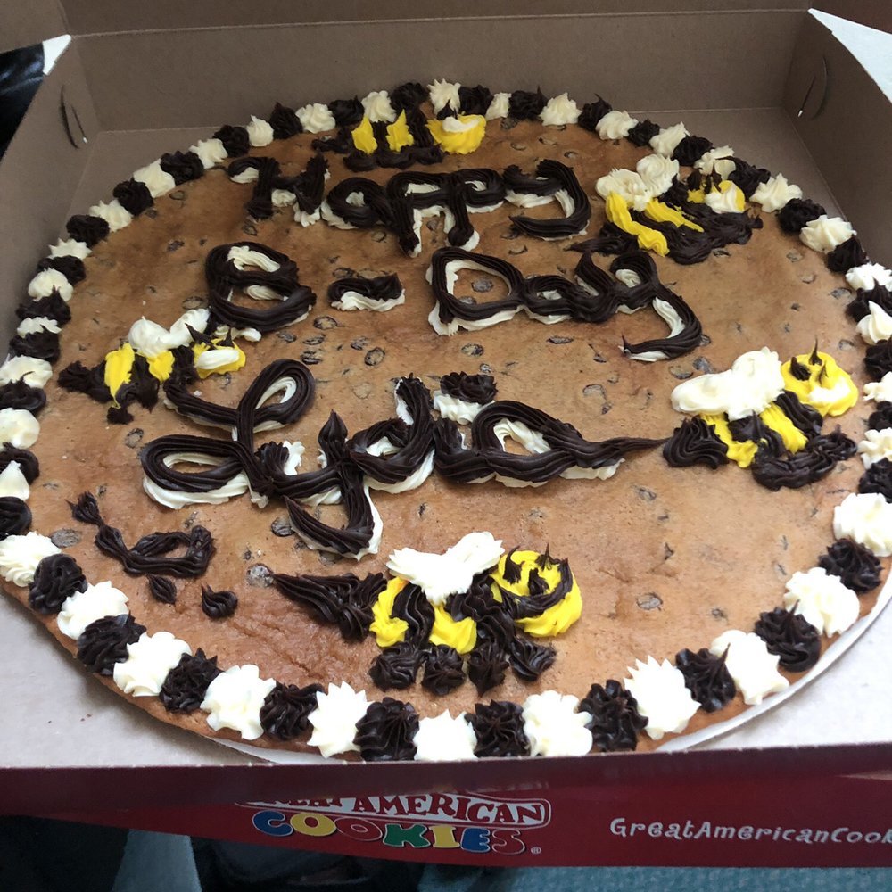 Great American Cookies - a chocolate chip cookie with white and yellow frosting - Bakeries Near Me - Branson, Missouri Great American Cookies - a chocolate chip cookie with white and yellow frosting - Bakeries Near Me - Branson, Missouri