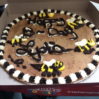 Great American Cookies - a chocolate chip cookie with white and yellow frosting - Bakeries Near Me - Branson, Missouri Great American Cookies - a chocolate chip cookie with white and yellow frosting - Bakeries Near Me - Branson, Missouri