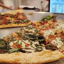 Mezzaluna Pizzeria at the European Village - Various pizza slices