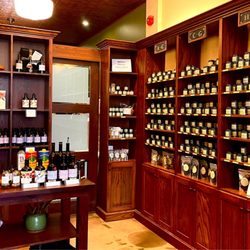 The Spice Trader - Alphabetized spice tins and olive oil tasting table