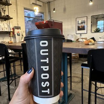 Outpost Coffee - a person holding a cup of coffee - Coffee & Tea Near Me - Bartlesville, Oklahoma Outpost Coffee - a person holding a cup of coffee - Coffee & Tea Near Me - Bartlesville, Oklahoma