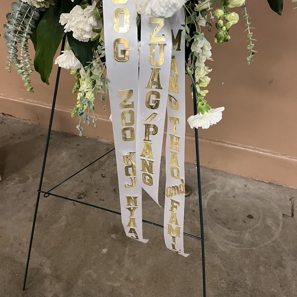 Aloha Floral - This is how the ribbon looks. Can't even read the first words. & the slash just makes the wording weird. - Florists Near Me - Merced, California Aloha Floral - This is how the ribbon looks. Can't even read the first words. & the slash just makes the wording weird. - Florists Near Me - Merced, California