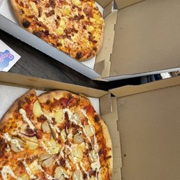two pizzas in open boxes two pizzas in open boxes