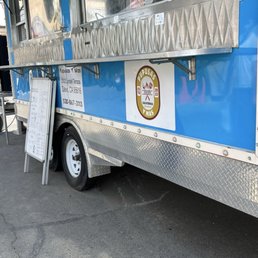 The taco truck stand w the business logo The taco truck stand w the business logo