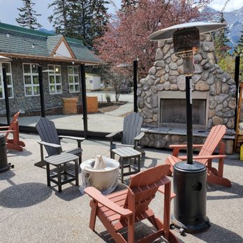 Table Food + Drink - a patio with chairs and a fire place - Canadian (New) Near Me - Canmore, Alberta
