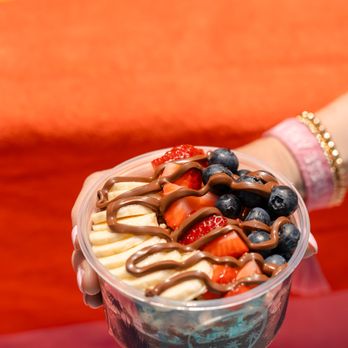 Surf Bar - a person holding a bowl of fruit - Acai Bowls Near Me - Edmond, Oklahoma