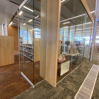 Central and Unser Library - Young Adults Room - Interior of a library's young adults room with glass walls, bookshelves, and modern lighting. - Libraries Near Me - Albuquerque, New Mexico