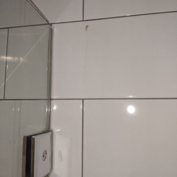 Builderwell Design & Build - Cracked subway tiles on a guest bathroom that's never been used - General Contractors Near Me - Irvine, California