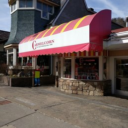 the outside of a restaurant with a red and white awning the outside of a restaurant with a red and white awning