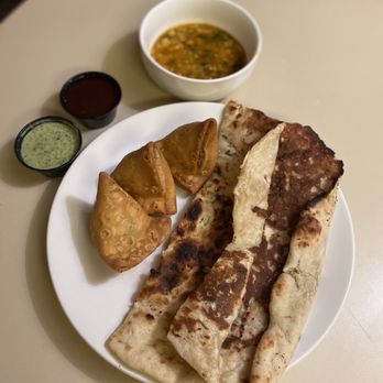 New India Cuisine - Garlic Naan, 3 Vegetable Samosas, Dal Soup(Bean Soup), Green Chutney (Sauce), Tamarind Sauce. - Indian Near Me - Phoenix, Arizona New India Cuisine - Garlic Naan, 3 Vegetable Samosas, Dal Soup(Bean Soup), Green Chutney (Sauce), Tamarind Sauce. - Indian Near Me - Phoenix, Arizona