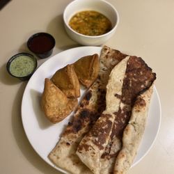 New India Cuisine - Garlic Naan, 3 Vegetable Samosas, Dal Soup(Bean Soup), Green Chutney (Sauce), Tamarind Sauce.