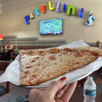 Patellini's Pizza - a hand holding a piece of pizza - Pizza Near Me - Sarasota, Florida Patellini's Pizza - a hand holding a piece of pizza - Pizza Near Me - Sarasota, Florida