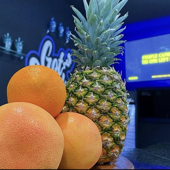 Got Smoke - a pineapple and oranges on a table - Vape Shops Near Me - Fairburn, Georgia