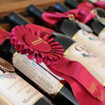 Golden Rule Vineyards - a row of wine bottles with ribbons - Wine Tasting Room Near Me - Cochise, Arizona Golden Rule Vineyards - a row of wine bottles with ribbons - Wine Tasting Room Near Me - Cochise, Arizona