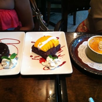Indochine - Desserts at Indochine. (L to R) Fudge chocolate cake, purple sticky rice w/sliced mango & coconut creme brulee. - Thai Near Me - Jacksonville, Florida Indochine - Desserts at Indochine. (L to R) Fudge chocolate cake, purple sticky rice w/sliced mango & coconut creme brulee. - Thai Near Me - Jacksonville, Florida
