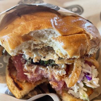 The Stand - American Classics Redefined - Even with that giant bite out of it...it still looks amazing!! So delicious!! - New American Near Me - San Juan Capistrano, California