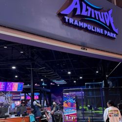 Altitude Trampoline Park - San Jose - The entrance of Altitude Trampoline Park in San Jose features the illuminated Altitude Trampoline Park sign above an open ent...