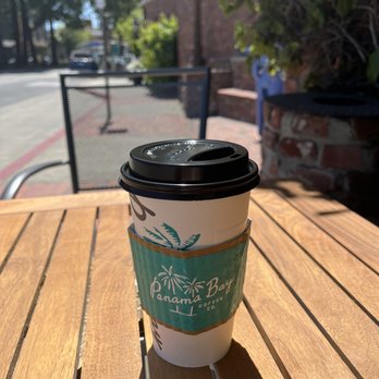 Panama Bay Coffee - a cup of coffee on a wooden table - Bakeries Near Me - Oakland, California Panama Bay Coffee - a cup of coffee on a wooden table - Bakeries Near Me - Oakland, California