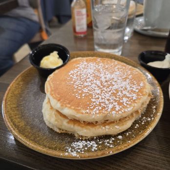 Brunch Berry - Pancakes with powder sugar and butter. It's also served with a bottle of warm syrup. - Coffee & Tea Near Me - New Berlin, Wisconsin