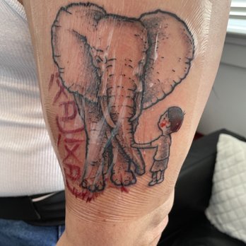 Hell or High Water Tattoo - This is to honor my dad. He loved elephants. The kid is supposed to be me. The red symbols mean "Ba Ba", or dad in Chinese. - Tattoo Near Me - New Orleans, Louisiana Hell or High Water Tattoo - This is to honor my dad. He loved elephants. The kid is supposed to be me. The red symbols mean "Ba Ba", or dad in Chinese. - Tattoo Near Me - New Orleans, Louisiana