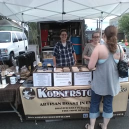 a man and a woman at a coffee stand