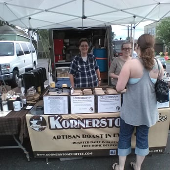 Kornerstone Coffee - a man and a woman at a coffee stand - Coffee Roasteries Near Me - Kenmore, New York