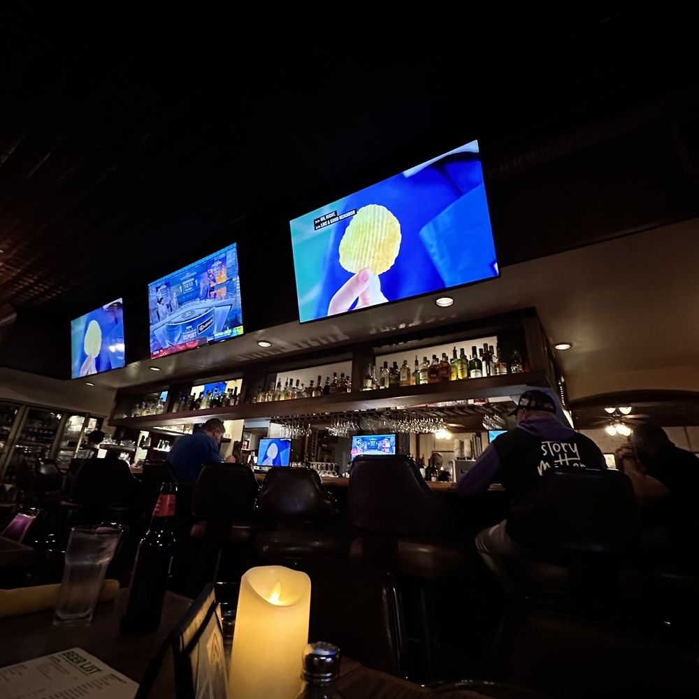 Arts Bar & Grill - Games showing and bar in middle of restaurant - Sports Bars Near Me - Riverside, California Arts Bar & Grill - Games showing and bar in middle of restaurant - Sports Bars Near Me - Riverside, California