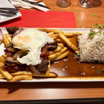 El Fogon - a plate of food on a table - Peruvian Near Me - Miramar, Florida El Fogon - a plate of food on a table - Peruvian Near Me - Miramar, Florida