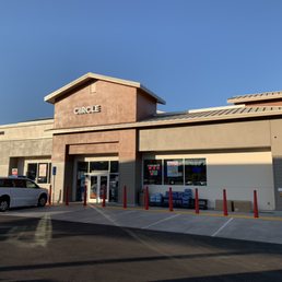 the outside of a store with a car parked in front of it the outside of a store with a car parked in front of it