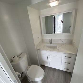 H Construction Corporation - bathroom with a toilet, sink, and mirror - General Contractors Near Me - Honolulu, Hawaii H Construction Corporation - bathroom with a toilet, sink, and mirror - General Contractors Near Me - Honolulu, Hawaii