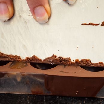 Edwart Chocolatier - The molds are shaved to remove excess. - Chocolatiers & Shops Near Me - Paris, 75