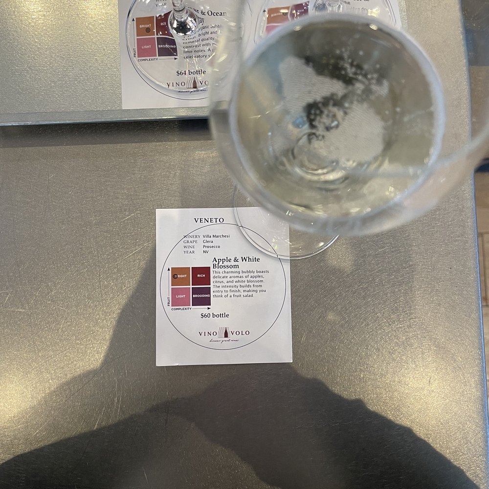 Vino Volo - a glass of wine with a label on it - Wine Bars Near Me - Calgary, Alberta Vino Volo - a glass of wine with a label on it - Wine Bars Near Me - Calgary, Alberta